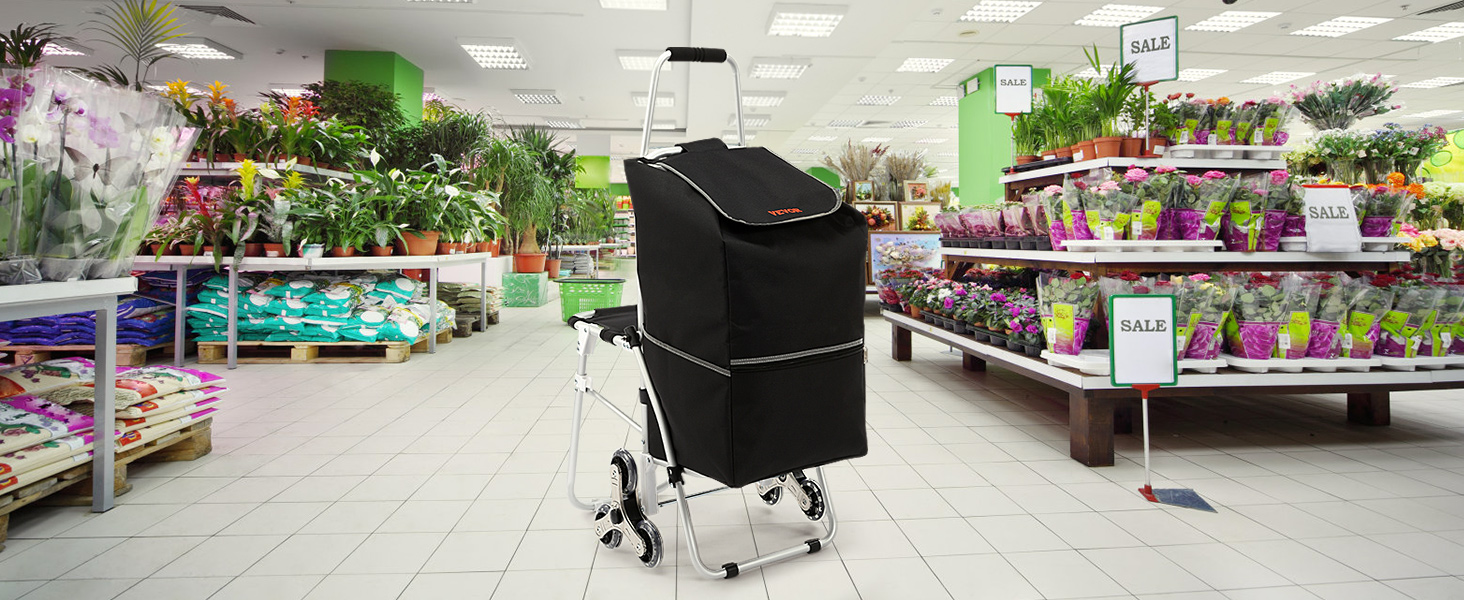 VEVOR stair climbing cart in a garden center with flower shelves and sale signs.