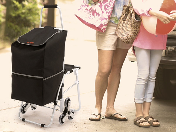 VEVOR stair climbing cart next to people unloading beach gear from an suv.