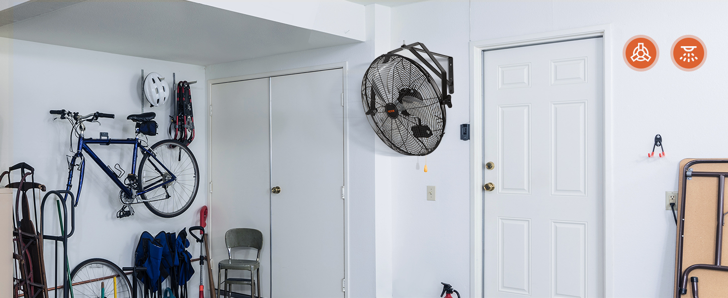garage with mounted bicycles, folded chairs, and a VEVOR wall mount fan on a white wall near the door.