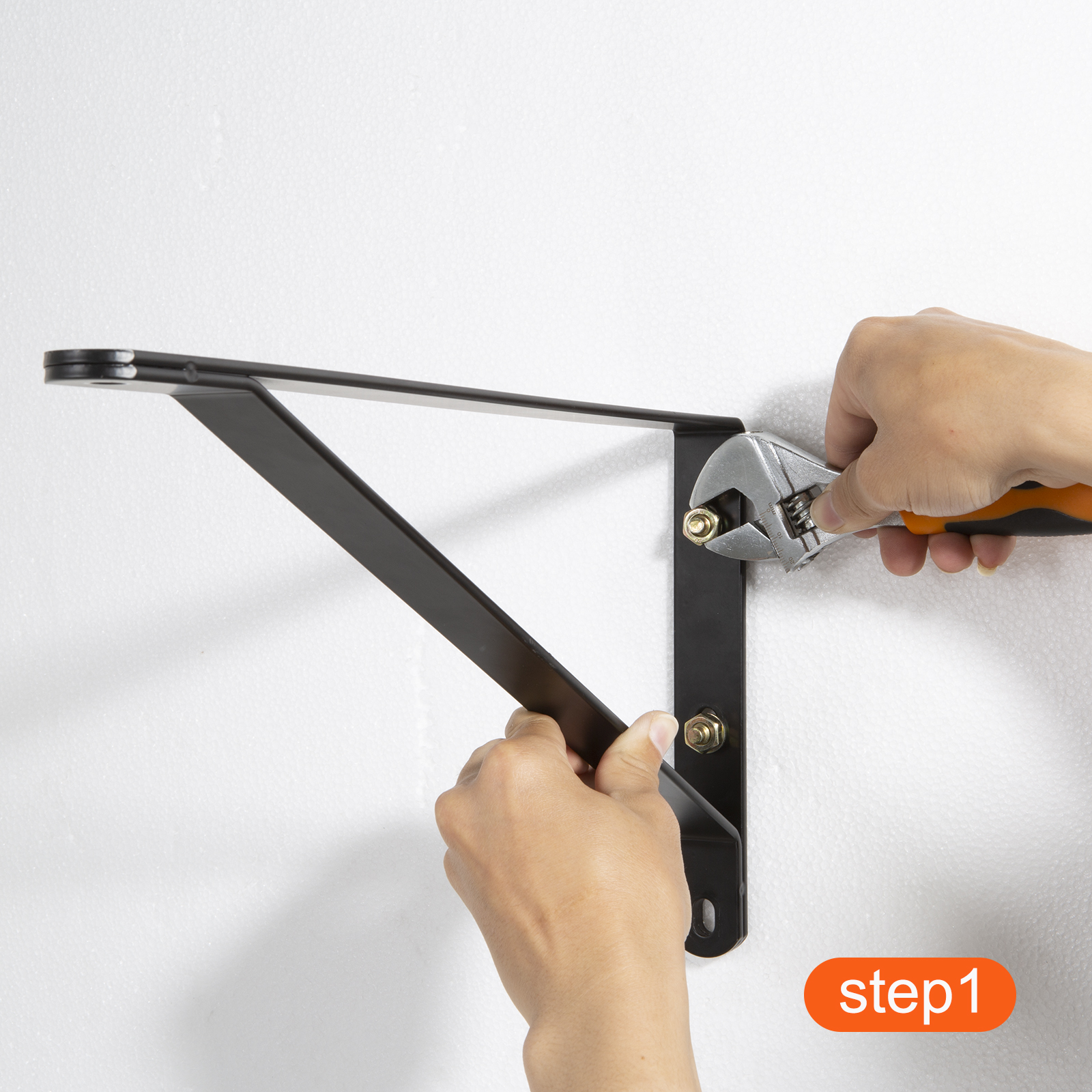 hand mounting VEVOR wall mount fan bracket on white wall with a wrench, labeled "step 1".