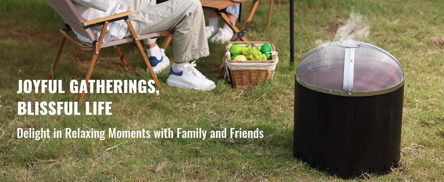 outdoor scene with VEVOR fire pit spark screen, people enjoying picnic with fruit basket on grass.