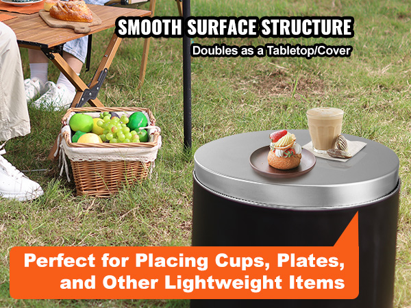 VEVOR fire pit cover used as a tabletop, holding drinks and snacks next to camping chairs and a picnic basket.