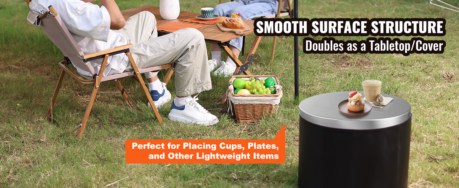 VEVOR fire pit cover used as a tabletop, holding drinks and snacks next to camping chairs and a picnic basket.
