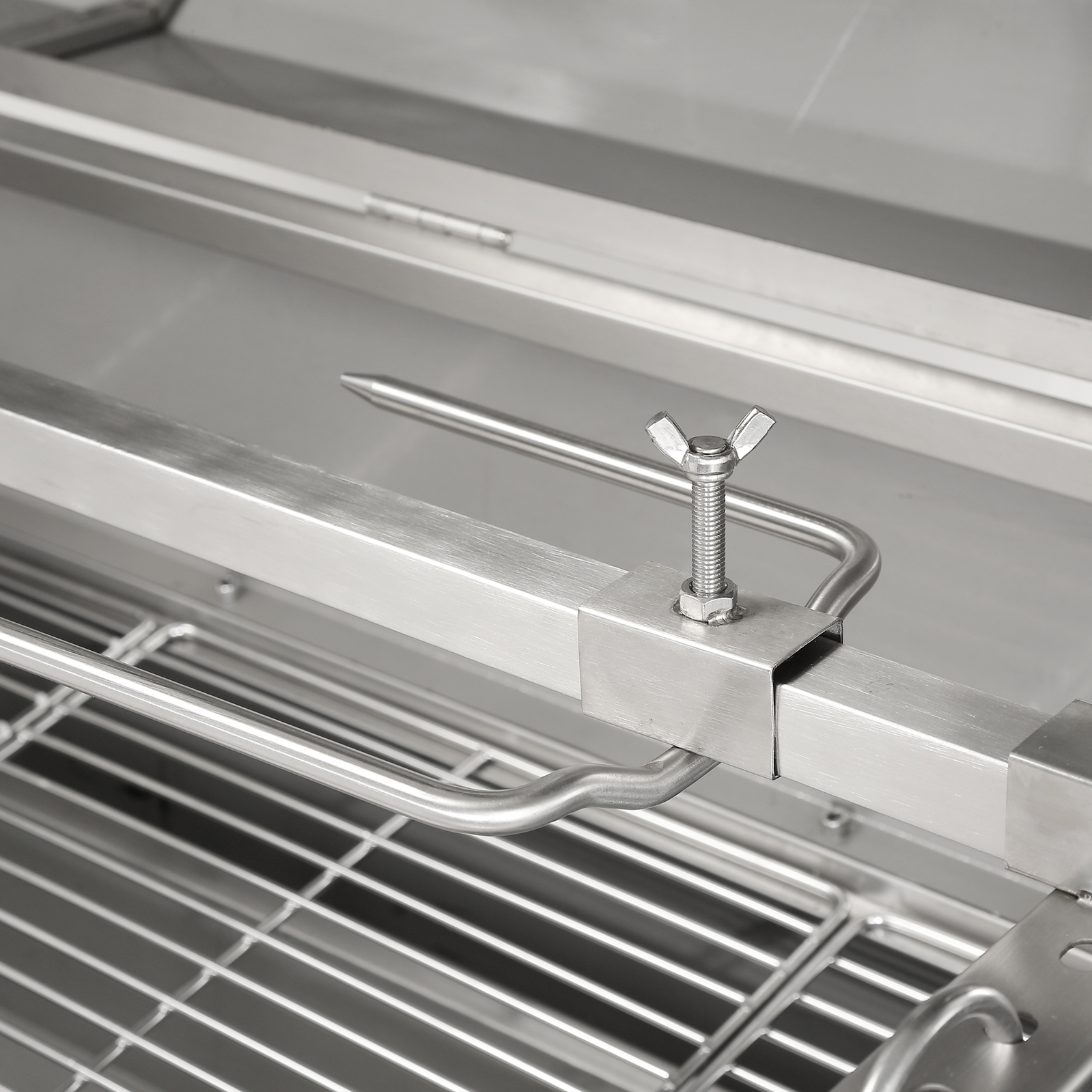 stainless steel VEVOR rotisserie grill showing the skewer clamp and grate details for outdoor cooking.