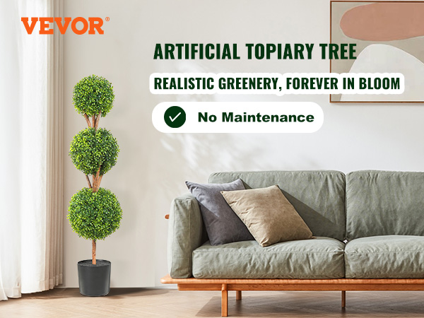VEVOR artificial topiary tree beside green sofa with cushions in a cozy, modern living room.