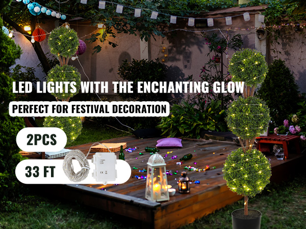 VEVOR artificial topiaries with led lights illuminating a festive, outdoor garden setting.
