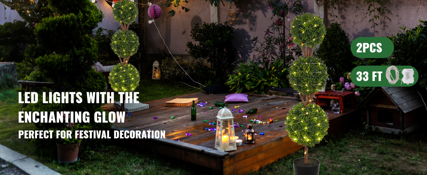VEVOR artificial topiaries with led lights illuminating a festive, outdoor garden setting.