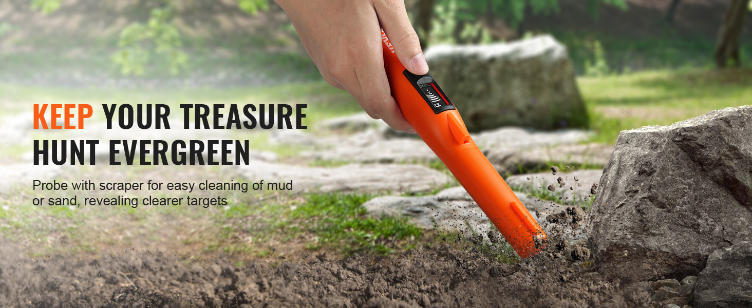hand using VEVOR metal detector pinpointer on rocky ground in a forested area with rocks and greenery.