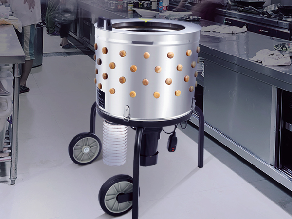 VEVOR chicken plucker in a commercial kitchen with stainless steel counters and utensils.