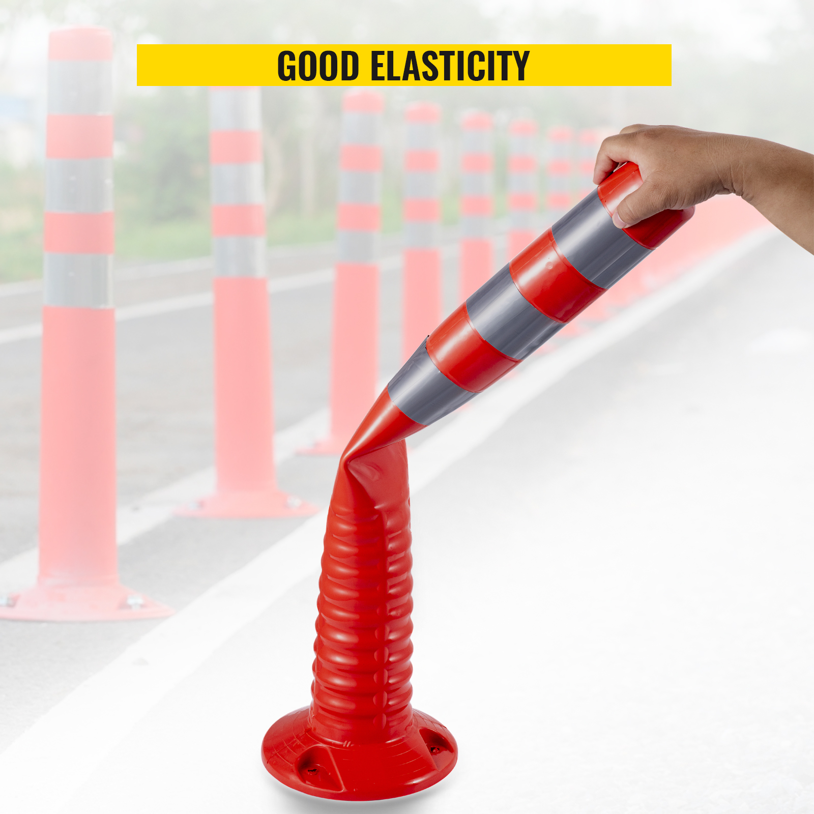 hand bending VEVOR traffic delineator cones showing good elasticity on the roadside.
