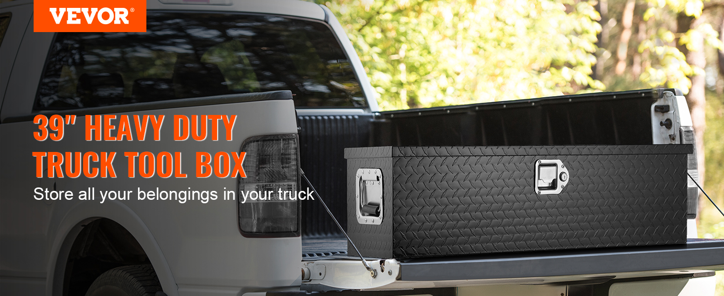 VEVOR truck bed tool box in open truck bed, heavy-duty black with diamond plate design, outdoors.
