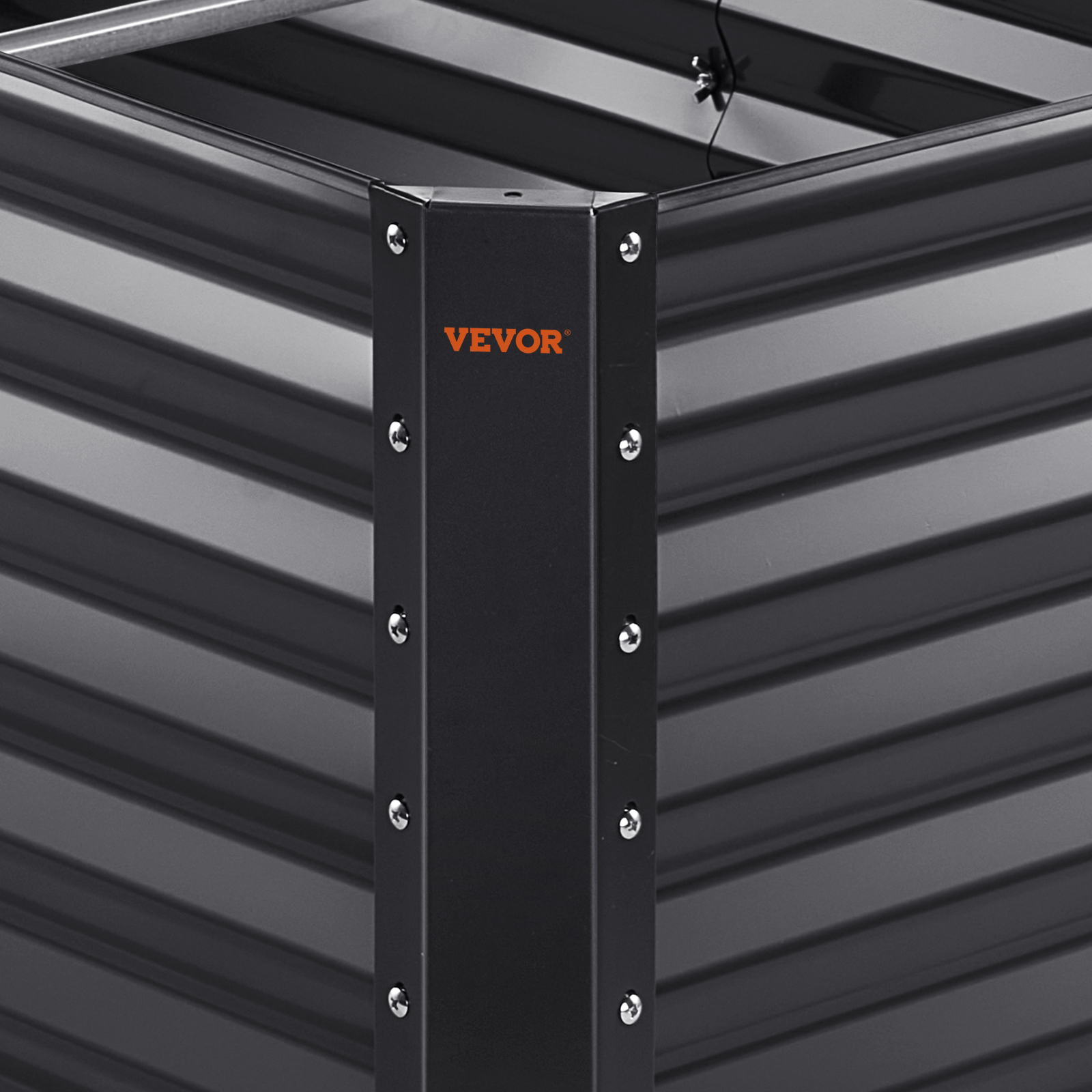 VEVOR garden bed corner detail with metallic screws and corrugated black panels.