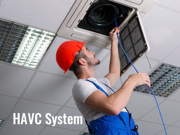 hvac technician inspecting ceiling air duct system