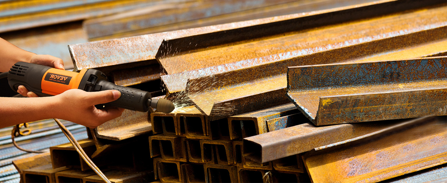 hands using VEVOR die grinder on a stack of rusted metal beams, with sparks flying.