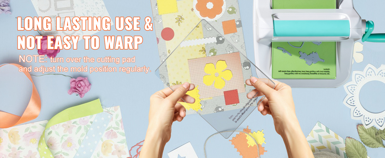 VEVOR die cutting machine, hands holding cutting pad, colorful craft paper and flowers in the background.