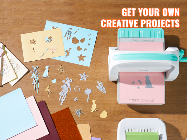 VEVOR die cutting machine on a table with craft paper, cutouts, and project materials.