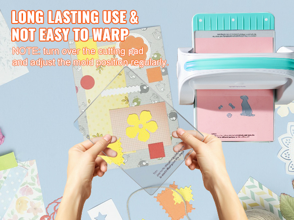 hands holding cutting pad with yellow floral die-cut next to VEVOR die cutting machine, craft supplies nearby.