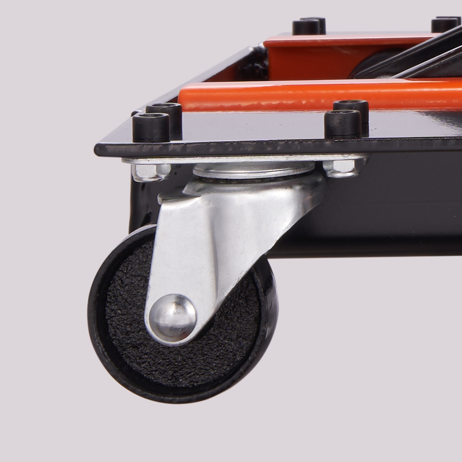 close-up of a caster wheel on a VEVOR motorcycle lift with a sturdy metal frame and orange accents.