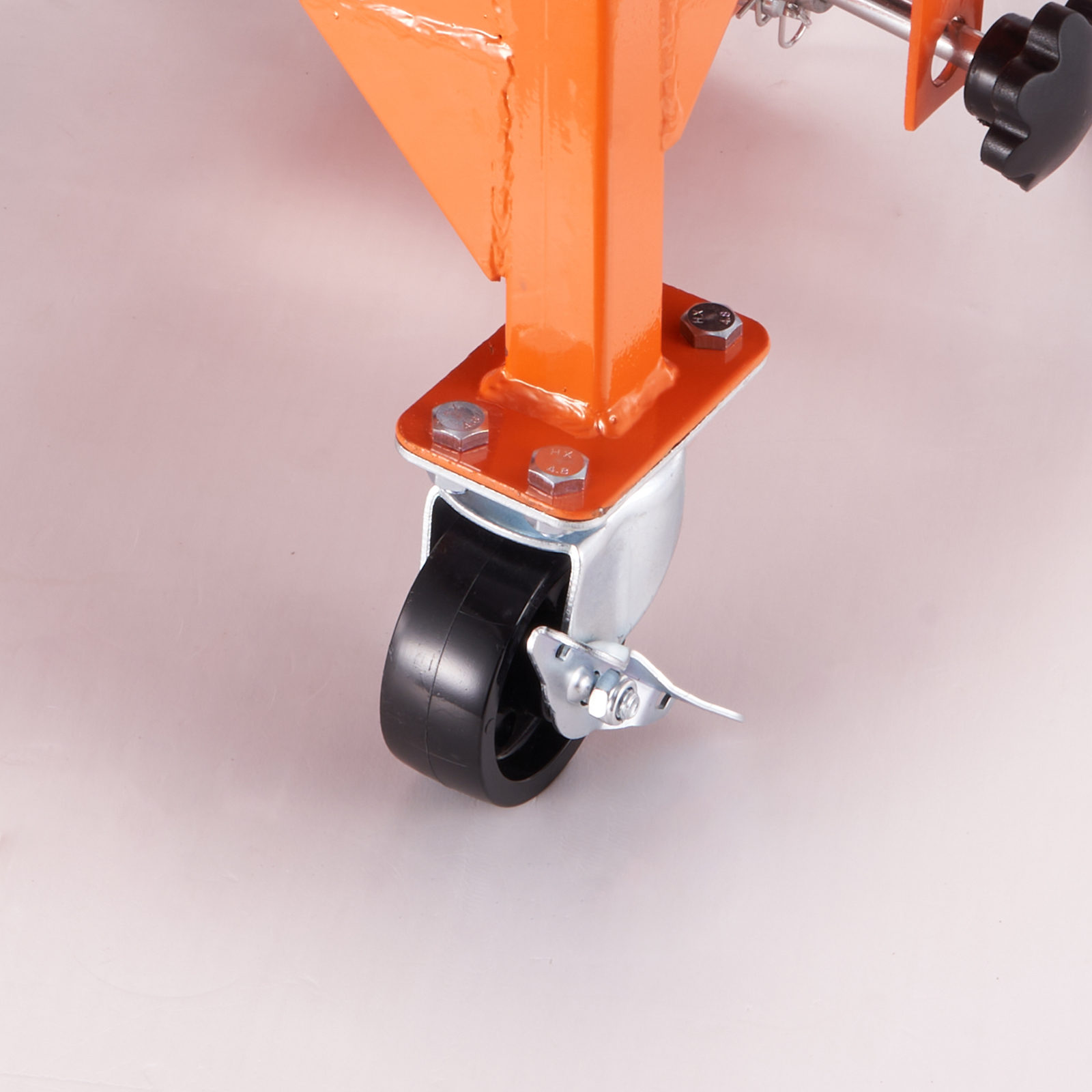 caster wheel of VEVOR hydraulic motorcycle lift with orange supporting frame and bolts.