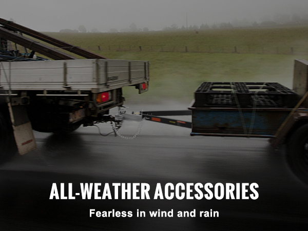 pickup truck towing trailer with a VEVOR tow bar in rainy weather, featuring security chain and brake line.