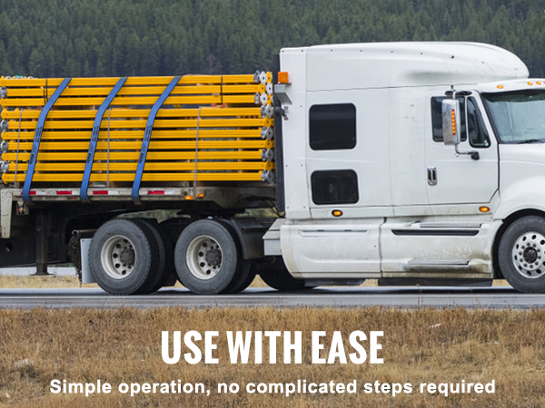 white semi-truck with yellow cargo secured by VEVOR winch straps on a rural road.