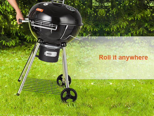 portable VEVOR kettle charcoal grill with wheels on green lawn, perfect for outdoor grilling.