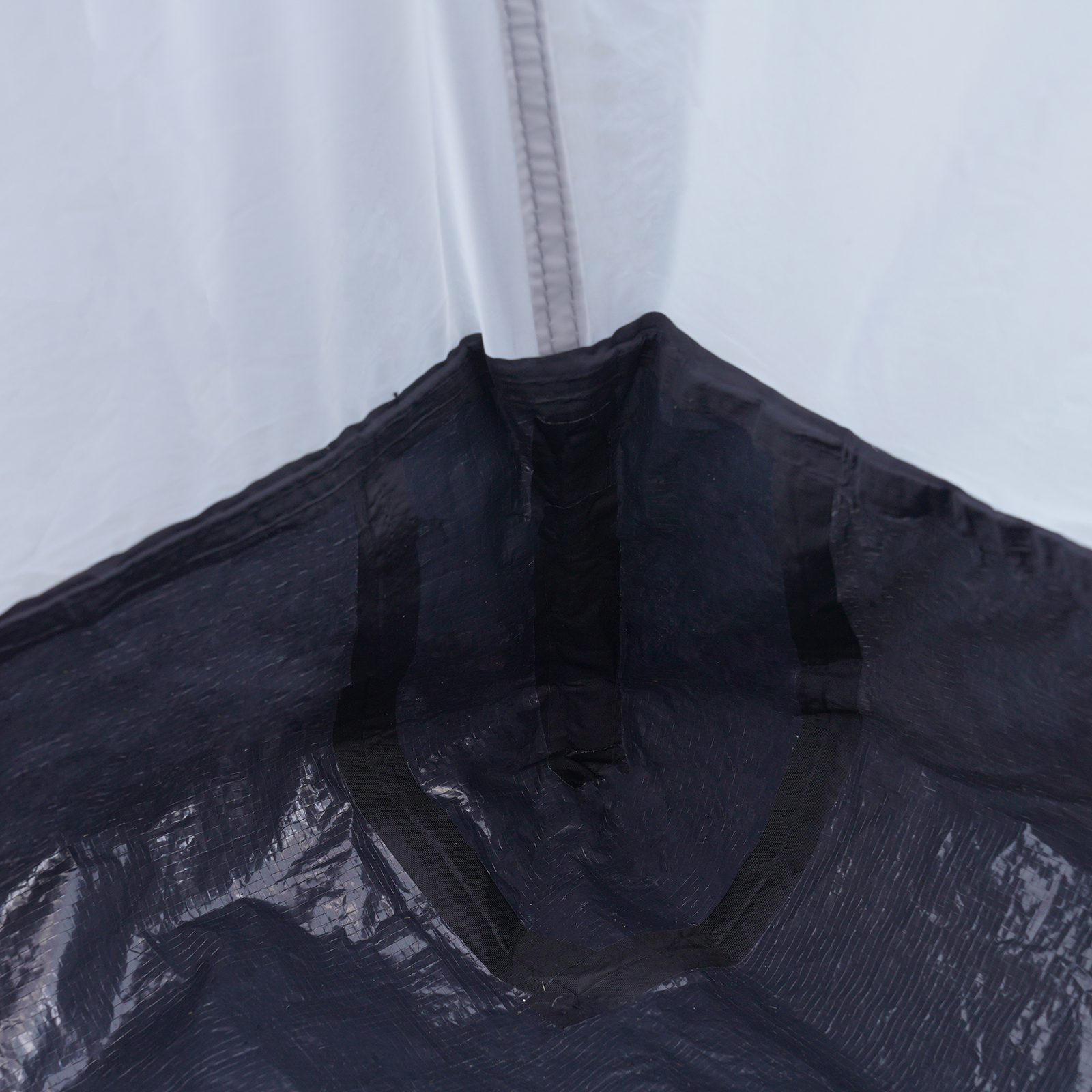 interior view of VEVOR truck bed tent corner, highlighting waterproof black and white fabric.