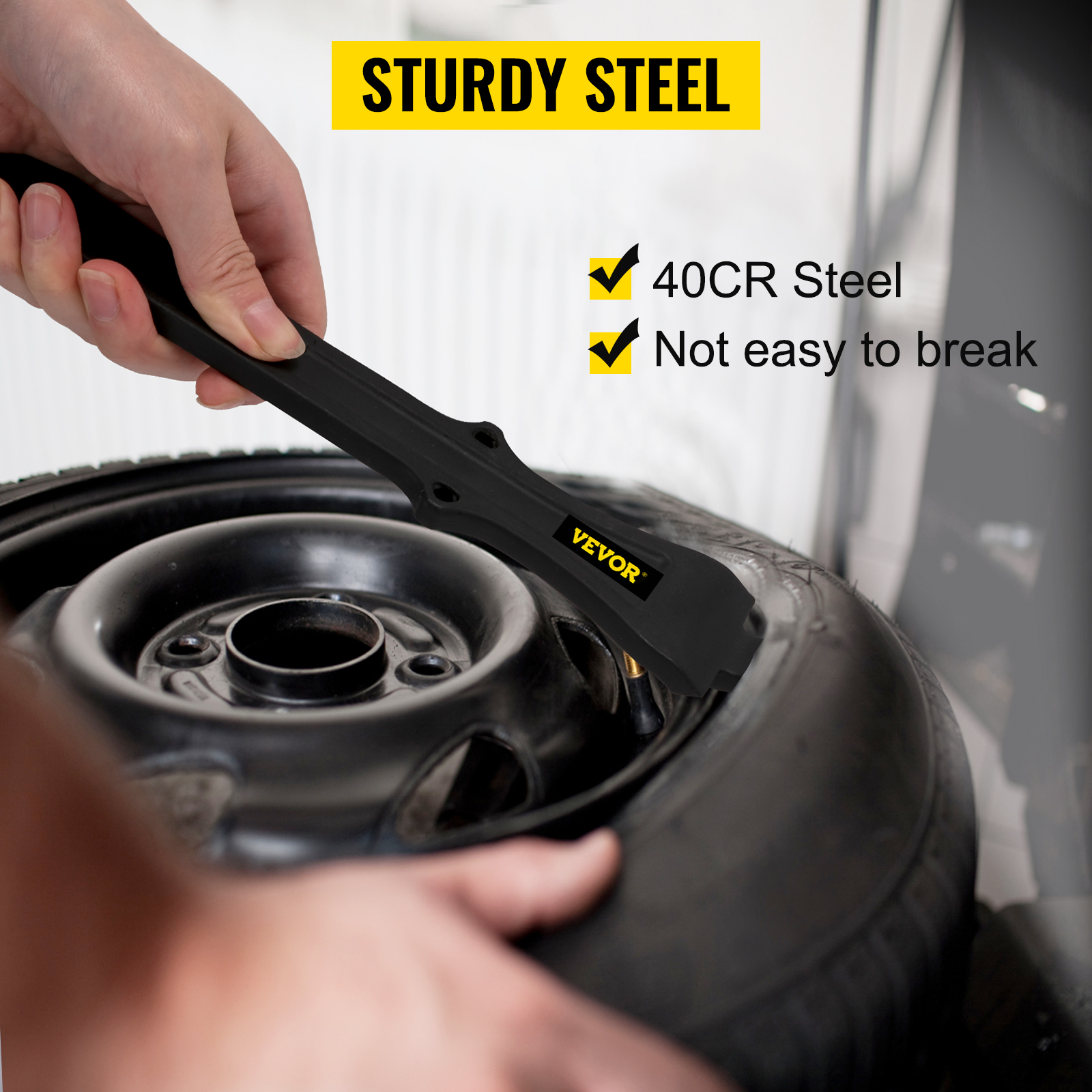 hand using VEVOR tire changing tool made of sturdy 40cr steel on a car tire.
