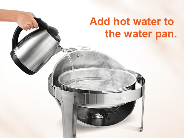 adding hot water to VEVOR roll top chafing dish, steam rising from water pan.