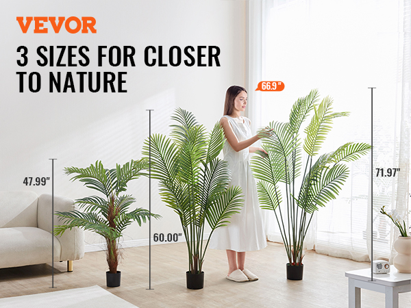 3 sizes of VEVOR artificial palm tree displayed beside a couch in a bright, modern room.