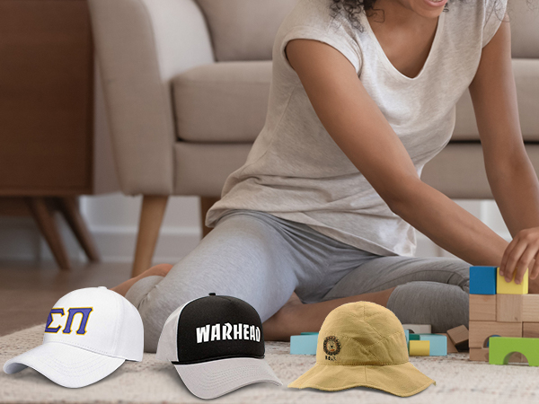 mother and child playing with blocks on carpet, featuring three custom hats made with the VEVOR hat heat press.