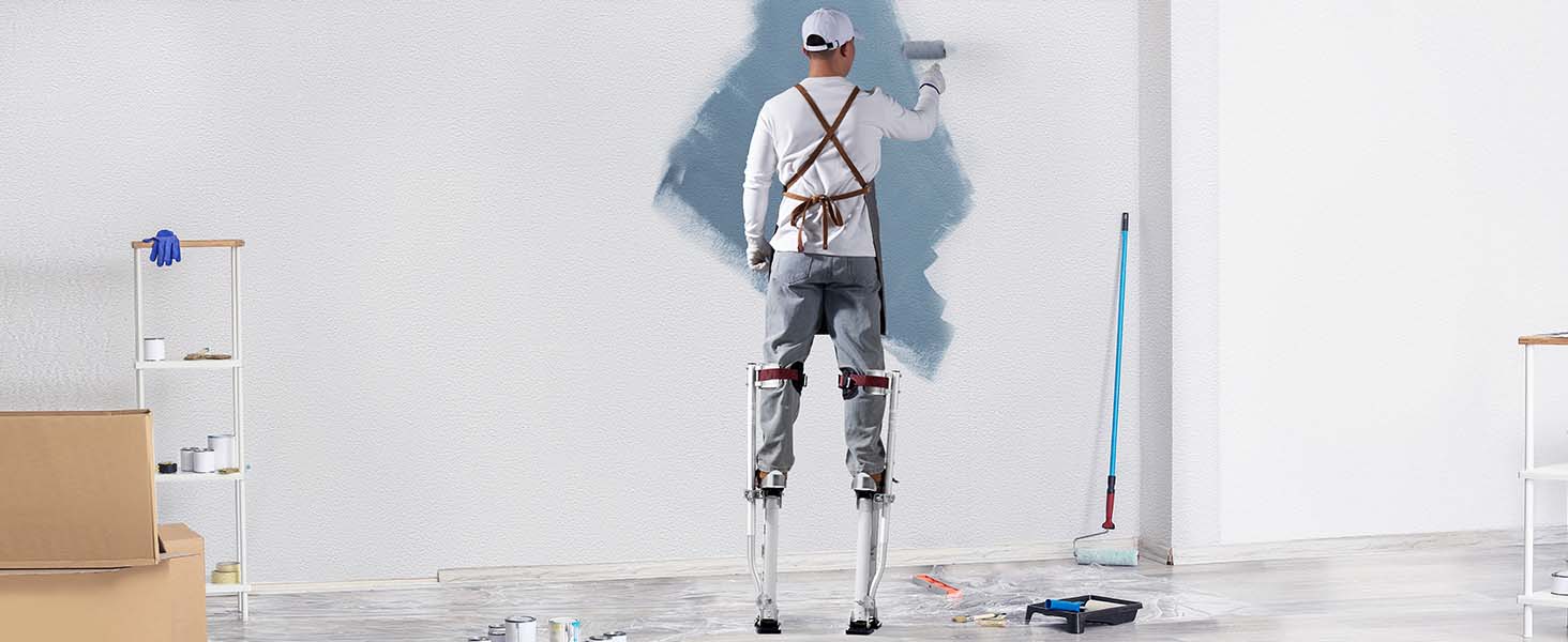 dailininkas naudojant VEVOR gipso polių dažų sienos, apsuptas dažymo įrankiai ir reikmenys.