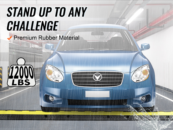 Zila automašīna brauc pa VEVOR kabeļu aizsarga rampu lietū, demonstrējot izturību un 12 000 mārciņu kravnesību.