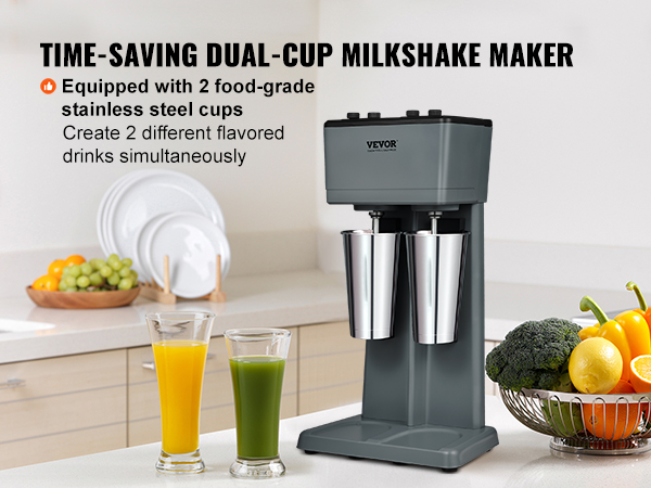 VEVOR milkshake maker in a modern kitchen with two stainless steel cups and fresh vegetables nearby.