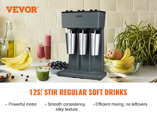 VEVOR milkshake maker with three stainless steel cups, fruit, and beverages on a kitchen counter.