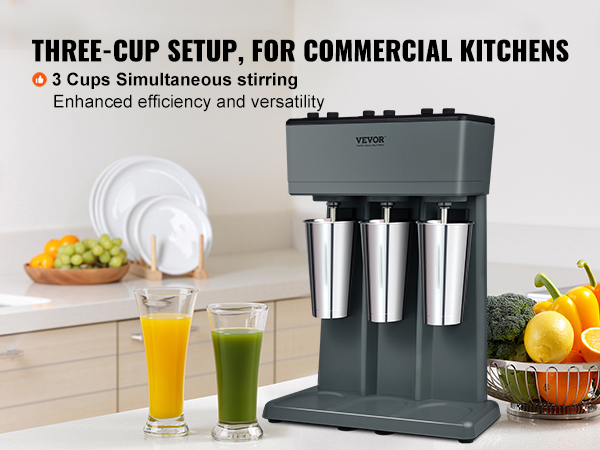 VEVOR milkshake maker in a kitchen with three stainless steel cups and fresh vegetables on the counter.