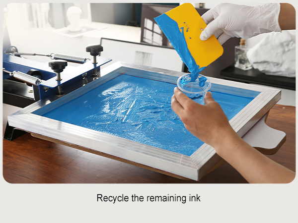 hand using spatula to recycle blue ink from screen in VEVOR screen printing kit.