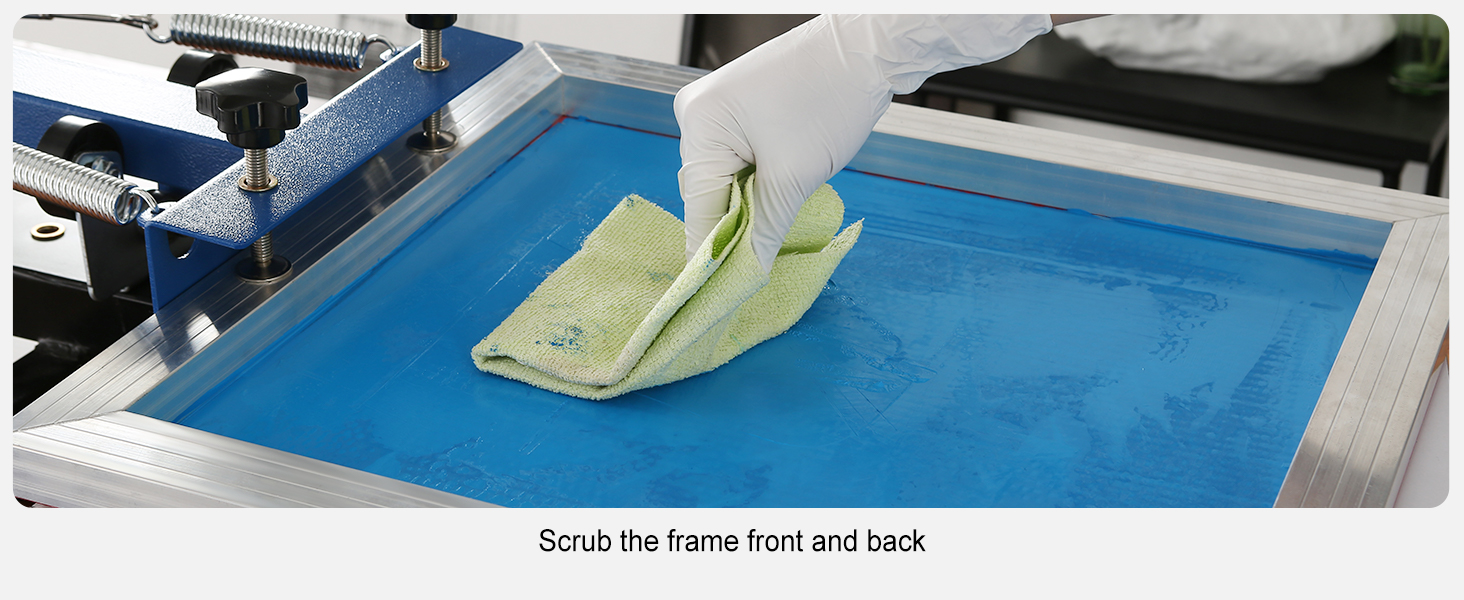 gloved hand cleaning a blue screen on a VEVOR screen printing kit with a green cloth.