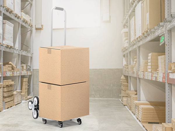 VEVOR stair climbing cart transporting cardboard boxes in a well-organized warehouse aisle.