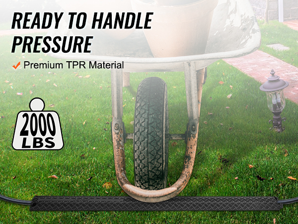 wheelbarrow on VEVOR speed bump, handling 2000 lbs, made of premium tpr material in a garden setting.