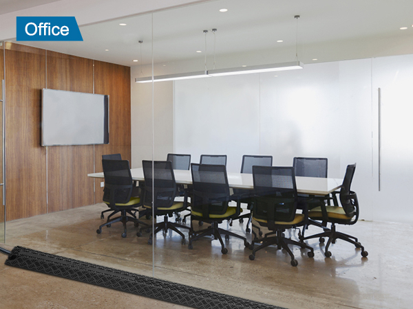 modern office conference room with glass walls, office chairs, and VEVOR speed bump on the floor.