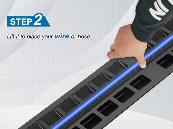 hand lifting VEVOR cable protector ramp to place a blue wire or hose. step 2 instructions displayed.
