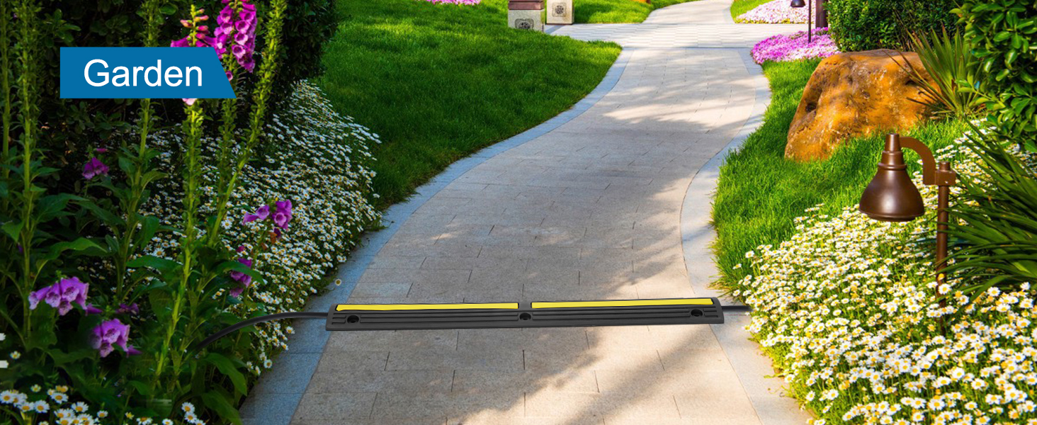 VEVOR cable protector ramp in a garden path with flowers, greenery, and outdoor lighting.