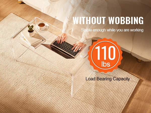 person working on a laptop at a VEVOR acrylic coffee table with a 110 lbs load capacity.