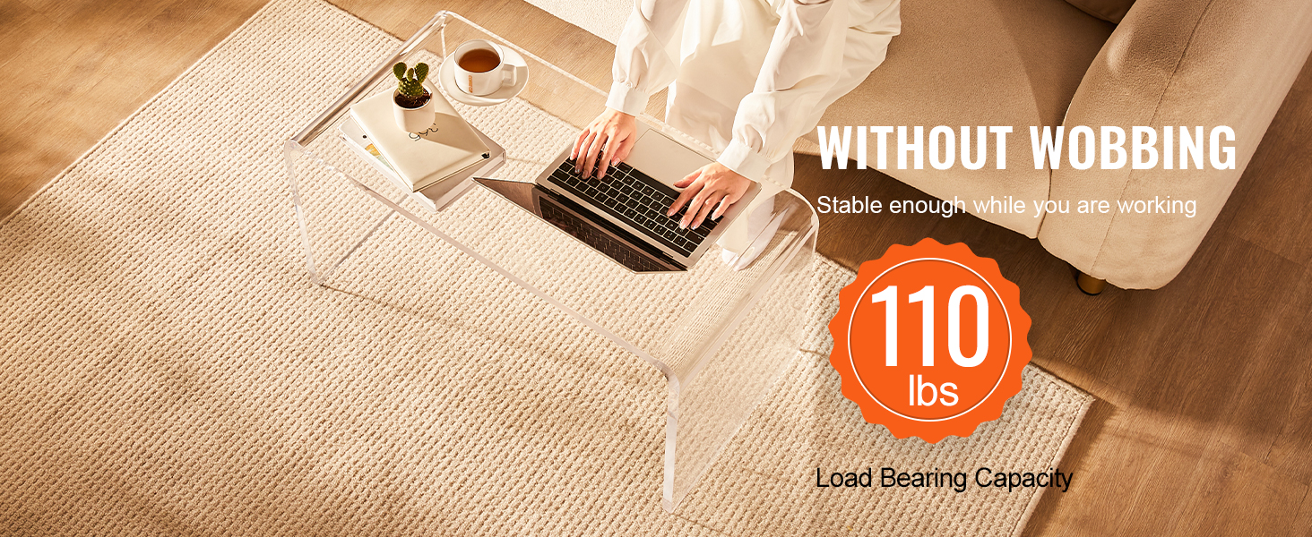 person working on a laptop at a VEVOR acrylic coffee table with a 110 lbs load capacity.