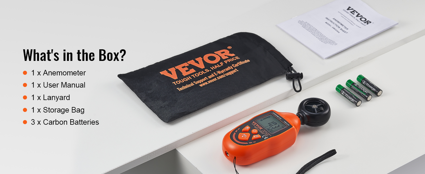 VEVOR handheld anemometer, storage bag, user manual, lanyard, and carbon batteries on a table.