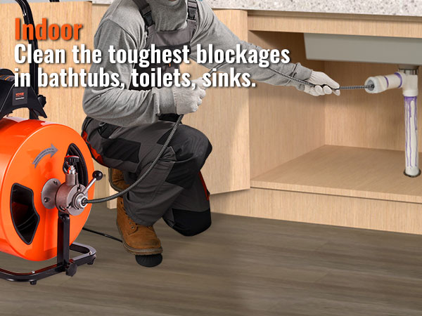 technician uses VEVOR drain cleaning machine to clear sink pipe blockage in kitchen.