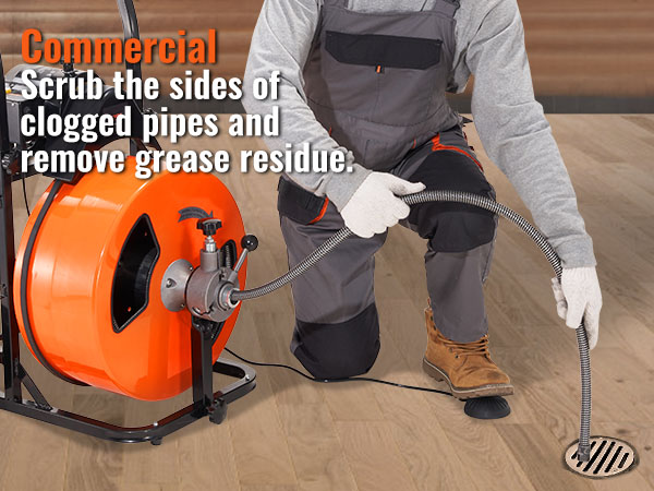 worker using VEVOR drain cleaning machine in commercial space to clear clogged pipes and grease residue.