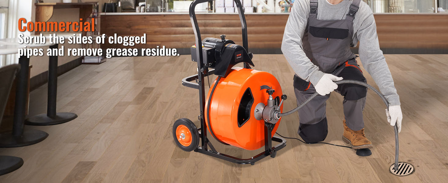 worker using VEVOR drain cleaning machine in commercial space to clear clogged pipes and grease residue.
