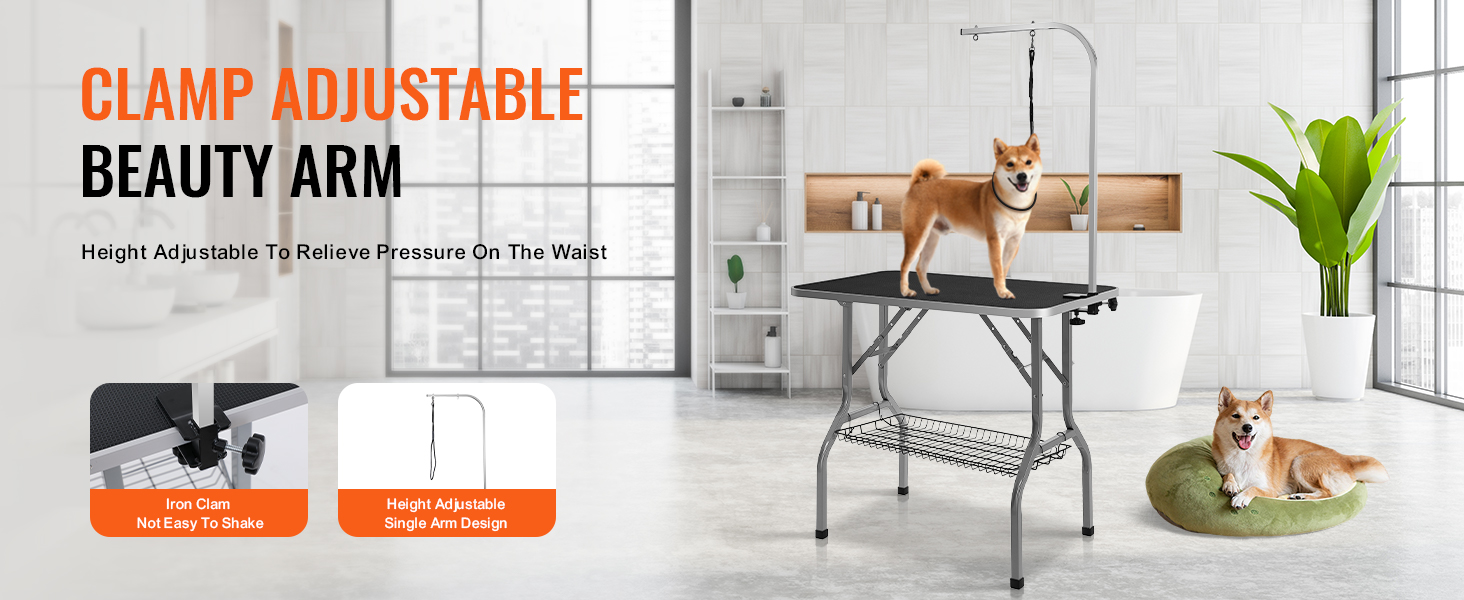 dog standing on VEVOR pet grooming table with adjustable arm, another dog resting on a green cushion nearby.